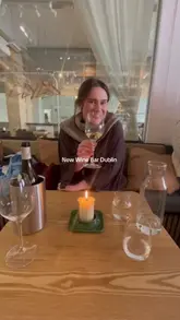 A short, personal vlog showcasing a new wine bar in Dublin. The creator highlights the interior, the extensive wine selection, and the relaxed atmosphere, making it look like an ideal spot for a casual catch-up.
