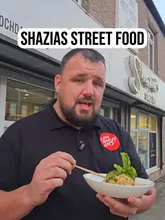 A food review of Shazias Street Food in Bury, featuring a unique Pakistani-style Scotch egg and various curries. The creator provides a detailed breakdown of the ingredients and flavours, while also showing the kitchen environment.
