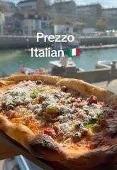 A promotional video for Prezzo in Weymouth, highlighting the harbour views, the menu, and the dining experience. The video features the creator showcasing the interior, the specials menu, the pizza, and the dessert, emphasizing the scenic location.