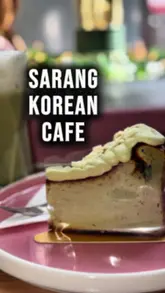 The creator visits Sarang Korean Cafe in Glasgow, providing a brief tour of the exterior and interior before reviewing their iced matcha and San Sebastian cheesecake. The video highlights the cafe's aesthetic and menu offerings.