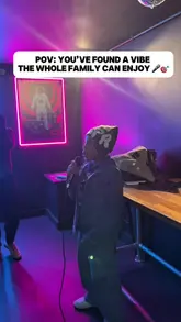 A high-energy vlog showcasing a visit to Boom Battle Bar, highlighting the various activities available such as karaoke, shuffleboard, and darts, alongside the food and drink offerings.