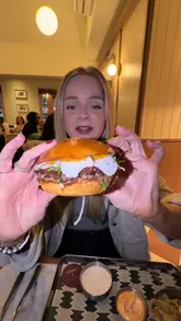 A gourmet burger from the Heard. Burger x Akoko collaboration, featuring a juicy patty and special toppings, created by Michelin-starred chefs in London.