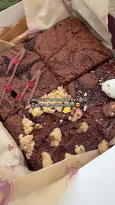 A short video showcasing a box of assorted gluten-free brownies from Brownie Alchemy, highlighting different flavors like salted caramel and Easter mini egg.