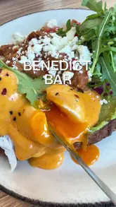A review of the 'Benny Bar' at Pot Kettle Black in Manchester, highlighting their extensive Eggs Benedict menu, including the Chilli Beef Brisket and Bury Black Pudding options. The video features the creator trying the food, showing the menu, and capturing the cafe's atmosphere.