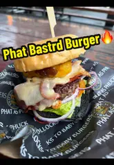 A vlog-style review featuring two creators trying burgers and loaded fries from Phat Bastrd Burger, located at the Botanic Inn in Belfast. The video highlights the quality of the food, including a Wagyu burger and salt and chilli chicken loaded fries, while also noting the venue's casual, outdoor setting.