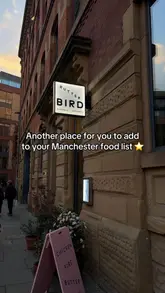 A straightforward, functional exterior shot of the restaurant 'Butter Bird' in Manchester, used to highlight the venue as a recommendation for a dinner spot.