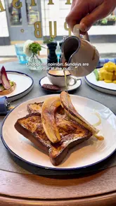 The video presents a brunch experience at The Blue Boar, highlighting various dishes like French toast, avocado toast, and eggs benedict, alongside a theatrical tableside Bloody Mary service. The footage is well-lit and professionally edited, capturing the cozy atmosphere of the pub.