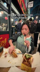 A creator reviews the Morley's x Roti King pop-up in Brixton Village, sampling the Sedap Wrap and fried chicken with nasi goreng. The video captures the casual atmosphere of the market and provides honest feedback on the flavours.