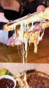 A fast-paced video showcasing a visit to Goodsheds street food hall in Barry, featuring close-ups of various dishes including a grilled cheese sandwich, sushi, pizza, and a wrap, interspersed with shots of the venue and people eating.