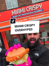 A candid food review of a chicken shop called Miami Crispy, where the creators evaluate the quality of their spicy chicken burger and wings. The video features the creators standing outside the venue, providing direct feedback on the texture and flavor of the food.