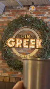 A family-oriented review of a Greek restaurant, featuring shots of various dishes like pita, hummus, meatballs, and gyros, while highlighting the venue's suitability for children.