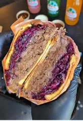 A fast-paced, visually appealing review of Billy's Smokehouse in West London, showcasing a variety of smoked meats including brisket, short ribs, and lamb chops, alongside sides like garlic mash and fries. The video uses close-up shots to emphasize the texture and quality of the food, accompanied by a descriptive voiceover.