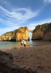 A travel montage showcasing a day in Lagos, Portugal, featuring scenic cliffside views, beach shots, local streets, and casual drinks.