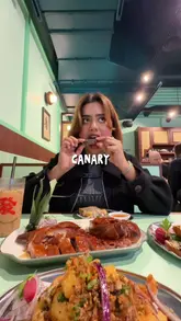 The video is a review of 'Mama Li,' a newly opened Cantonese restaurant in Canary Wharf. The creator provides a tour of the interior, highlighting the Hong Kong-inspired decor, and samples a variety of dishes including roast duck, Singapore vermicelli, prawn toast, salt and pepper king prawns, duck spring rolls, and a bolo bao with butter.