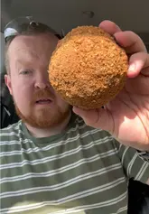 A creator visits Easter Compton Farm Shop to review their homemade Scotch Egg. He provides a detailed critique of the texture, seasoning, and quality of the egg and sausage meat, ultimately giving it a high rating and recommending the venue.