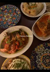 A video review of Parosna in Didsbury, Manchester, featuring the creator trying various dishes including butter chicken flatbread, grilled prawns, Madras chicken tenders, sea bass, lamb tacos, and a pistachio tiramisu. The video highlights the restaurant's concept of mixing and matching plates.