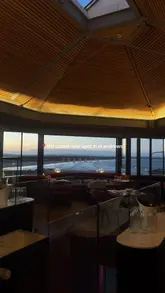 A short, atmospheric montage showcasing the interior, views, and menu offerings of Clarets in St Andrews, featuring shots of champagne, salmon canapés, and sandwiches.