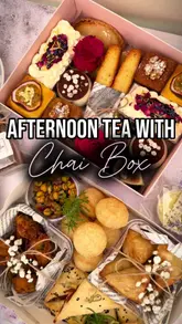 A high-quality, aesthetic showcase of two curated food boxes from Chai Box LDN, featuring a variety of savoury Indian-inspired snacks and fusion desserts. The video highlights the presentation, packaging, and individual items through close-up shots and slow pans, creating a desirable, premium feel for an at-home afternoon tea experience.