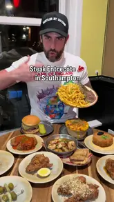 A food review video featuring a creator visiting The Alexandra pub in Southampton. The video highlights various dishes including steak entrecôte, French onion mac and cheese, chicken tenders, prawns, crab cakes, and a burger. The creator provides commentary on the quality and flavors of the food, while also showing behind-the-scenes kitchen preparation.