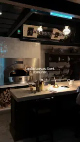 A short, punchy reel showcasing a variety of dishes at a new Greek restaurant in London, focusing on close-up shots of food preparation and serving.