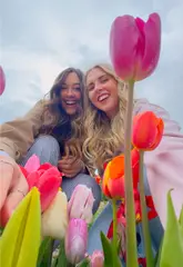 A bright and cheerful vlog-style video showcasing a visit to the Farmer Copleys Tulip Festival. The footage highlights the vast fields of tulips, the windmill, the Ferris wheel, and the creators enjoying the experience, effectively promoting it as a scenic day out.
