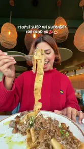 The creator presents a curated list of five distinct dining venues in Guernsey, Channel Islands, ranging from Italian and Japanese restaurants to a hotel dining experience. The video features high-quality shots of various dishes, including wagyu pasta, fresh sashimi, steak, and oysters, interspersed with the creator's enthusiastic commentary and personal reactions.