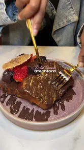 The video features a variety of desserts from Dolce Desserts in Stechford, including waffles, French toast, ice cream, and a 'Love Box' for sharing. It uses quick cuts and upbeat music to showcase the menu and the venue's interior.