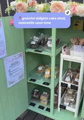 The video features a creator visiting a newly opened 'cake shed' in Newcastle, providing a tour of the small outdoor structure, showcasing the variety of baked goods available, and highlighting the purchase process, including a raffle incentive.