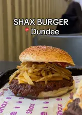 A food review video featuring a creator trying various burgers, wraps, loaded fries, and sides at Shax in Dundee.