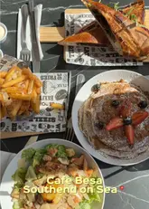 A vlog-style review of Cafe Besa in Southend-on-Sea, featuring a tour of the menu, drinks, and a variety of brunch dishes including a chicken caesar salad, a goat cheese and beetroot baguette, and biscoff pancakes.