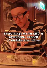 A review of a tasting menu at Gymkhana, a 2 Michelin star Indian restaurant in London. The creator walks through the courses, including poppadoms, deep-fried seafood, quail seekh kebab, butter chicken, and falooda dessert, providing commentary on the flavors and textures.