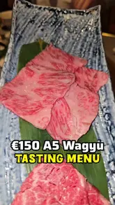 A review of a new Japanese Yakiniku restaurant in Dublin, focusing on their €150 A5 Wagyu tasting menu. The video features close-ups of the raw and cooked meat, the cooking process on the grill, side dishes, and the restaurant's interior.