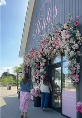 A short, aesthetic-focused tour of Heidi's in Runwell, highlighting the floral decor, cherry blossom tree, and menu items like Eggs Benedict, iced coffee, and pancakes.