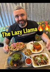 A couple reviews The Lazy Llama, a BBQ restaurant in Desertmartin. They showcase the venue's interior and outdoor seating, the menu, and several dishes including pork chops, loaded fries, brisket chili pie, and beef short rib.