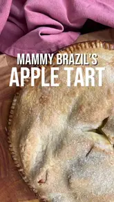 A home cooking tutorial demonstrating how to make a traditional apple tart, featuring step-by-step instructions from the creator in their kitchen.
