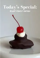 A short, aesthetic video demonstrating the assembly of a Black Forest Gateau-flavored madeleine. The process includes piping batter, filling with cherry, adding cream, and dipping in chocolate, resulting in a highly appetising final product.