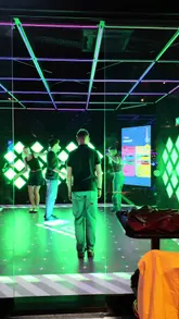 A group of friends visits Super Social in Dublin, showcasing various interactive games like shuffleboard, mini-golf, and floor-based reaction games, alongside drinks and pizza.