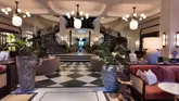 A walkthrough tour of the Six Senses London hotel, showcasing the lobby, cafe, bar, and outdoor courtyard area. The video highlights the interior design, including the mirrored ceiling and comfortable seating, while explaining that the cafe is open to the public.