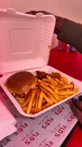 A direct-to-camera review of a local chicken shop, featuring a taste test of various menu items including Nashville hot chicken, peri-peri chicken, and a smash burger.