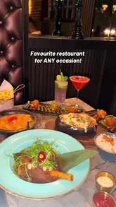 A promotional video for CoCo in Canary Wharf, featuring a montage of cocktails with smoke effects, cheese-heavy dishes, and the restaurant's floral-themed interior.