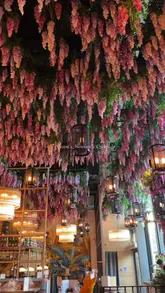 A montage-style video showcasing the interior and menu of Victors restaurant in Newcastle. The video features shots of the floral-decorated ceiling, the bar area, and various dishes including sushi, halloumi, and a burger, accompanied by background music.