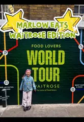 A young child explores the Waitrose World Tour event, sampling a wide variety of food items from different stations, including pizza, desserts, and savory snacks. The video uses a fast-paced, vlog-style edit to capture her reactions and the diverse food offerings available at the event.