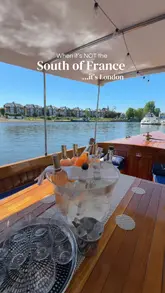 A visually appealing montage showcasing The Mitre Hampton Court, highlighting its riverside location, boat access, and outdoor dining area. The video uses a 'South of France' theme to emphasize the venue's aesthetic appeal and relaxing atmosphere, featuring shots of rosé wine and guests enjoying the sunny weather.