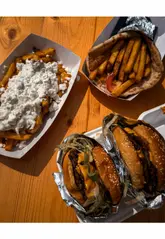 A fast-paced, handheld-style video showcasing a street food festival at The Halfway in Llanelli. The video features a wide variety of food vendors, including loaded fries, gyros, tacos, pizza, hot dogs, and various desserts, capturing the lively atmosphere of the event.