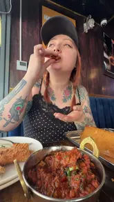 A video review of a vegetarian Indian restaurant in Bedford, highlighting their new mock meat menu and a promotional offer for a free beer.