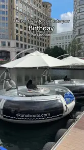 A group of friends celebrates a birthday on a Skuna BBQ boat in Canary Wharf, London. The video captures the experience of grilling food on the water, drinking, and enjoying the scenic surroundings.