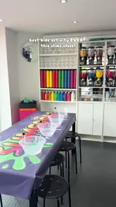A short, energetic video showcasing a slime-making class at Slimedom in East London. The footage captures the step-by-step process of mixing ingredients, adding glitter and charms, and playing with the finished slime, highlighting it as a fun activity for children.