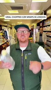 The video features a creator visiting a convenience store in Mayfair, London, to try a viral 'chopped wrap' trend. The creator showcases the preparation process, including chopping the salad and ingredients, and provides a taste test of the final product.