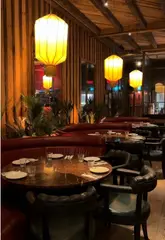 A visually appealing montage showcasing the interior and food offerings of Mama Yo restaurant in Dublin, featuring cocktails, various Asian dishes, and dessert.