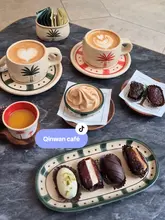 A short, aesthetic video showcasing the newly opened Qinwan cafe in London, highlighting their coffee, date selection, and date-based soft serve. The video features close-up shots of the food and drink, as well as the cafe's interior and outdoor terrace seating.